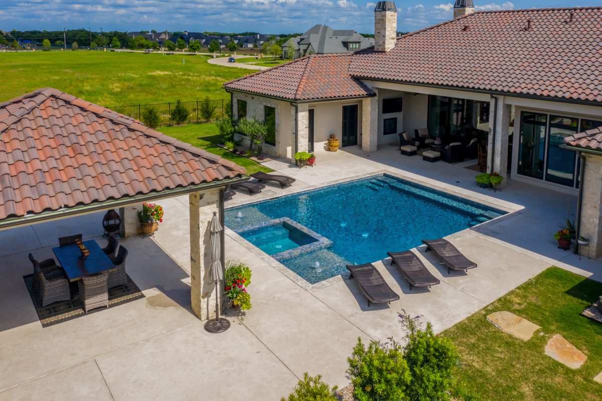 Pool technician cleaning a residential pool